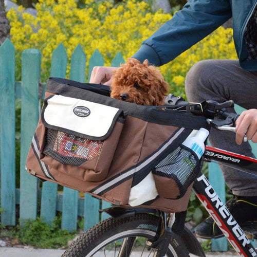 Dog Hugs Cat Bikepaws Pet Traveler removable front bicycle carrier for small cats and dogs, attached to a bicycle handlebars.